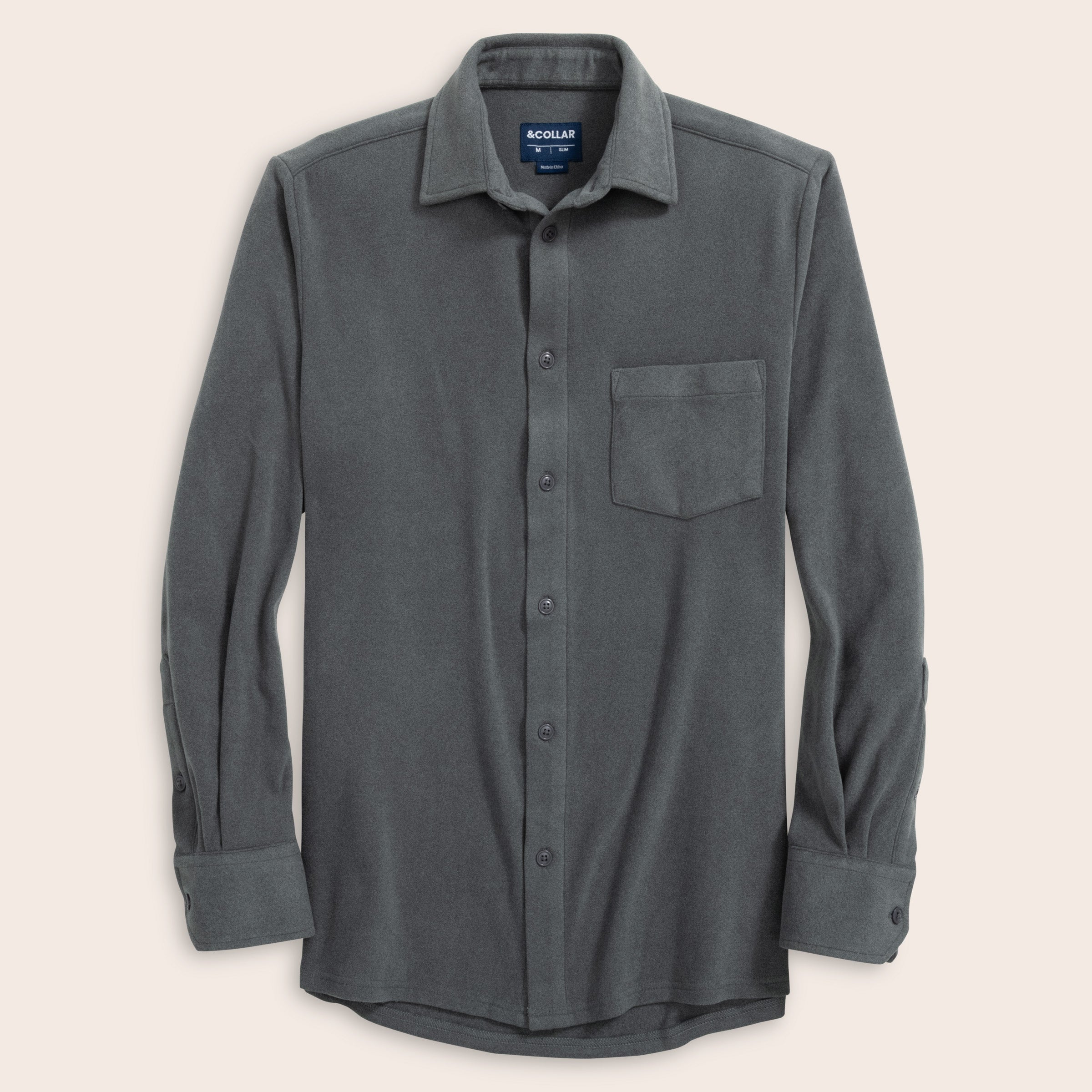 Charcoal gray button-up flannel shirt with a collar on a beige background