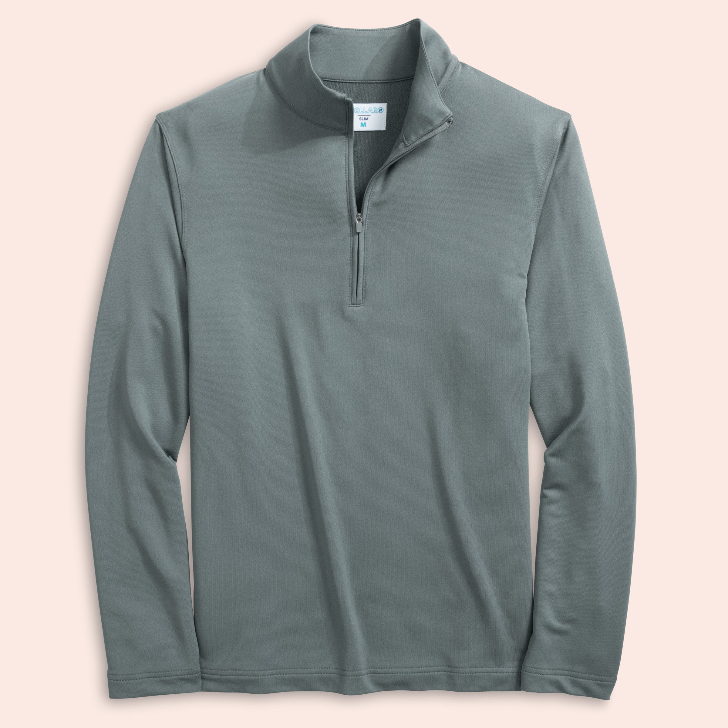 Steel gray long-sleeve quarter zip on a light pink background