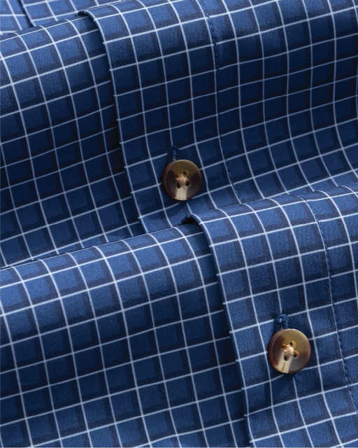 Close-up of a navy w/ white and blue check shirt with tortoise shell buttons