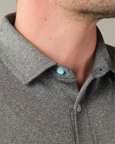 Detail shot heather grey polo shirt. Top button blue ring