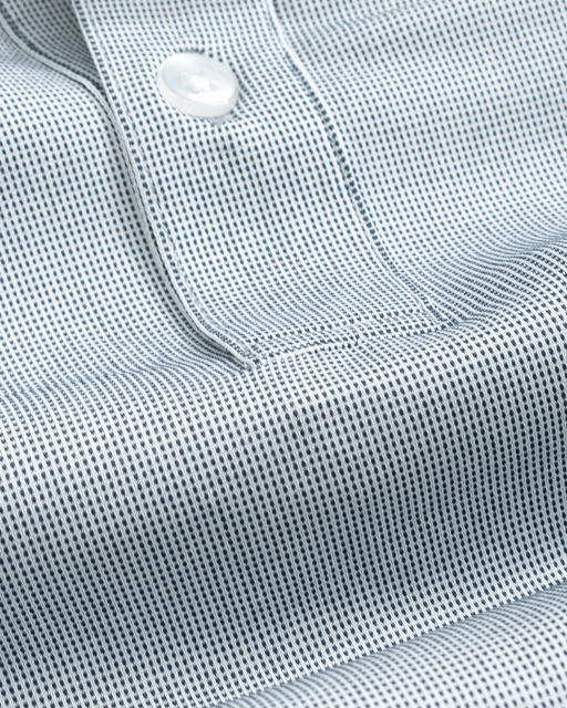 Close-up of a a steel gray short sleeve polo shirt fabric showing texture with a button detail