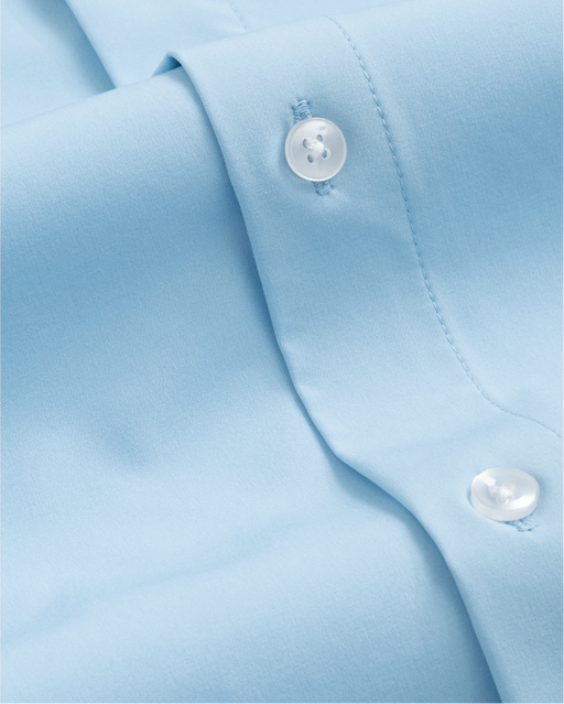 Close up of French blue button up shirt with opaque clear-looking buttons. 