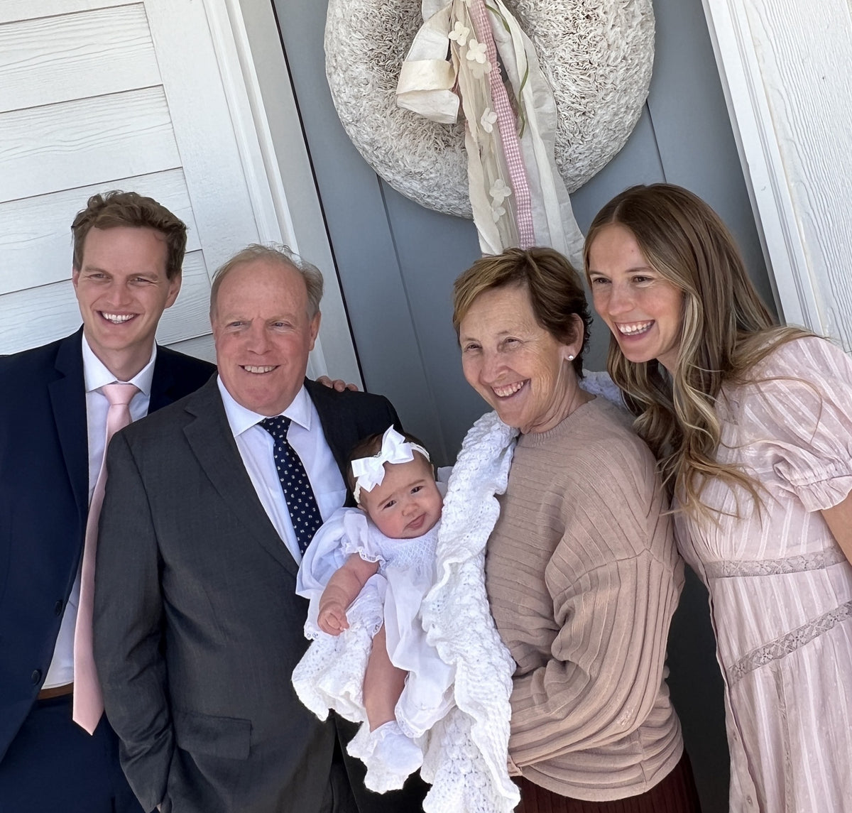 Three generations in white shirts and suits after church