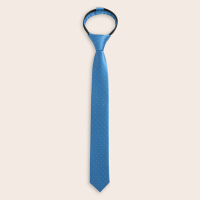 Blue zipper tie with a subtle white dots on a light beige background