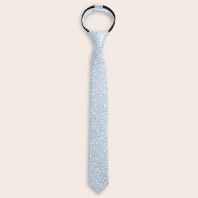 Light blue patterned zipper tie on a beige background