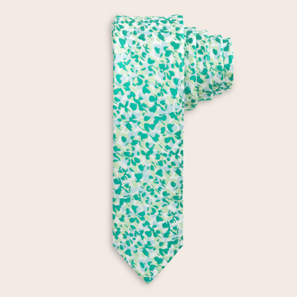 Green patterned tie on a beige background