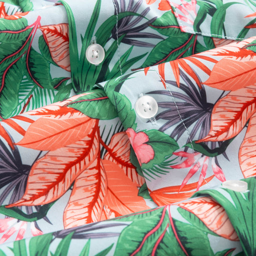 Close up of Hawaiian shirt with tropical leaf pattern.