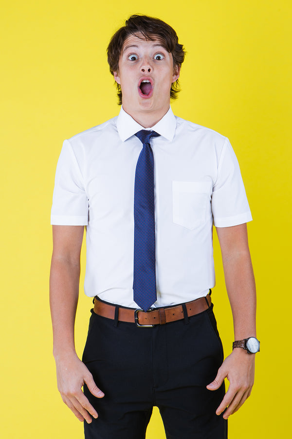 Navy blue tie with red polka dots on a white shirt
