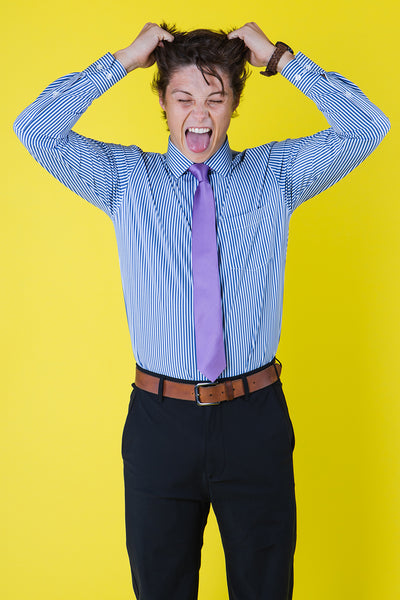 Purple striped tie on a blue shirt