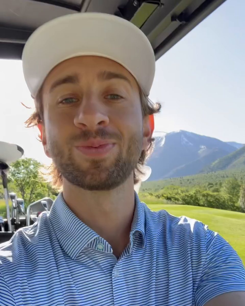 Golfer on the course in a blue striped &Collar Tropic polo