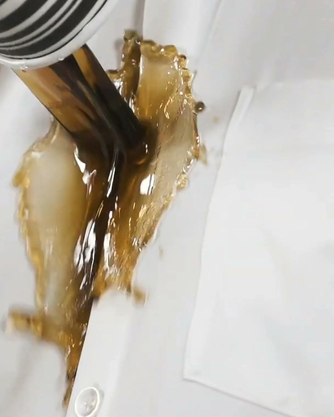 Coffee pouring down the front of a white &Collar shirt and rolling off